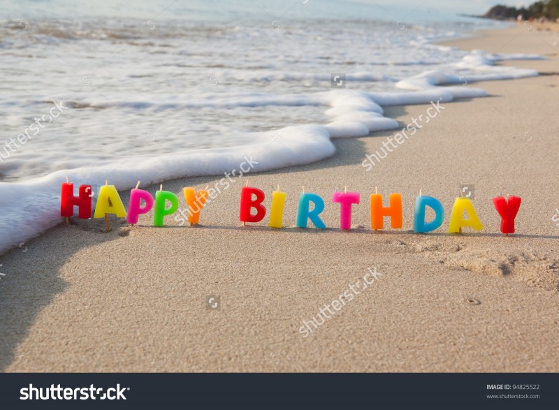stock-photo-happy-birthday-candles-on-a-beach-94825522.jpg